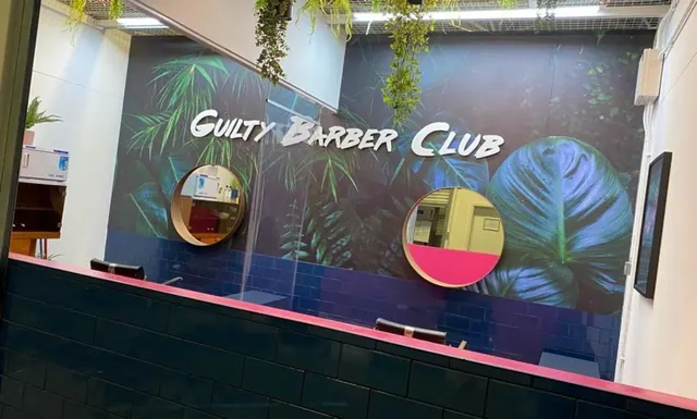 The mirrors and mural at Guilty Barber Club